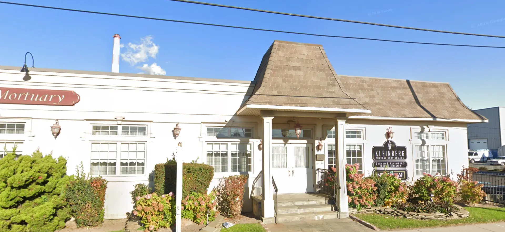 Exterior of 3930 Long Beach Road, Island Park NY — white two-story former funeral home with porte-cochère